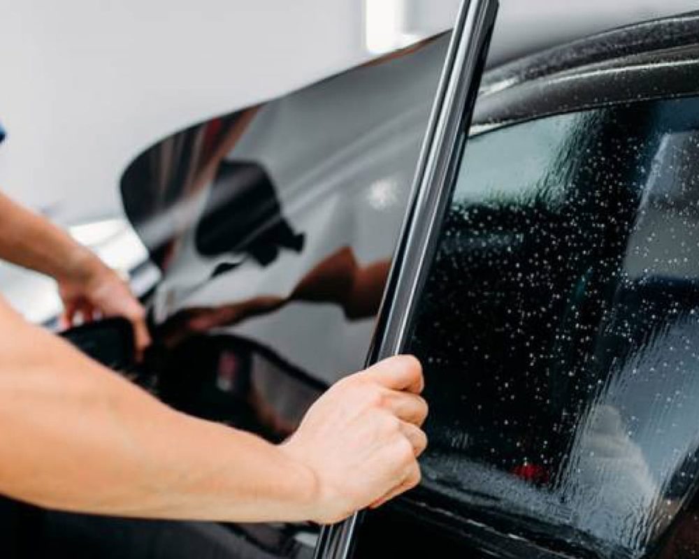 Sun control film being fitted to a car window